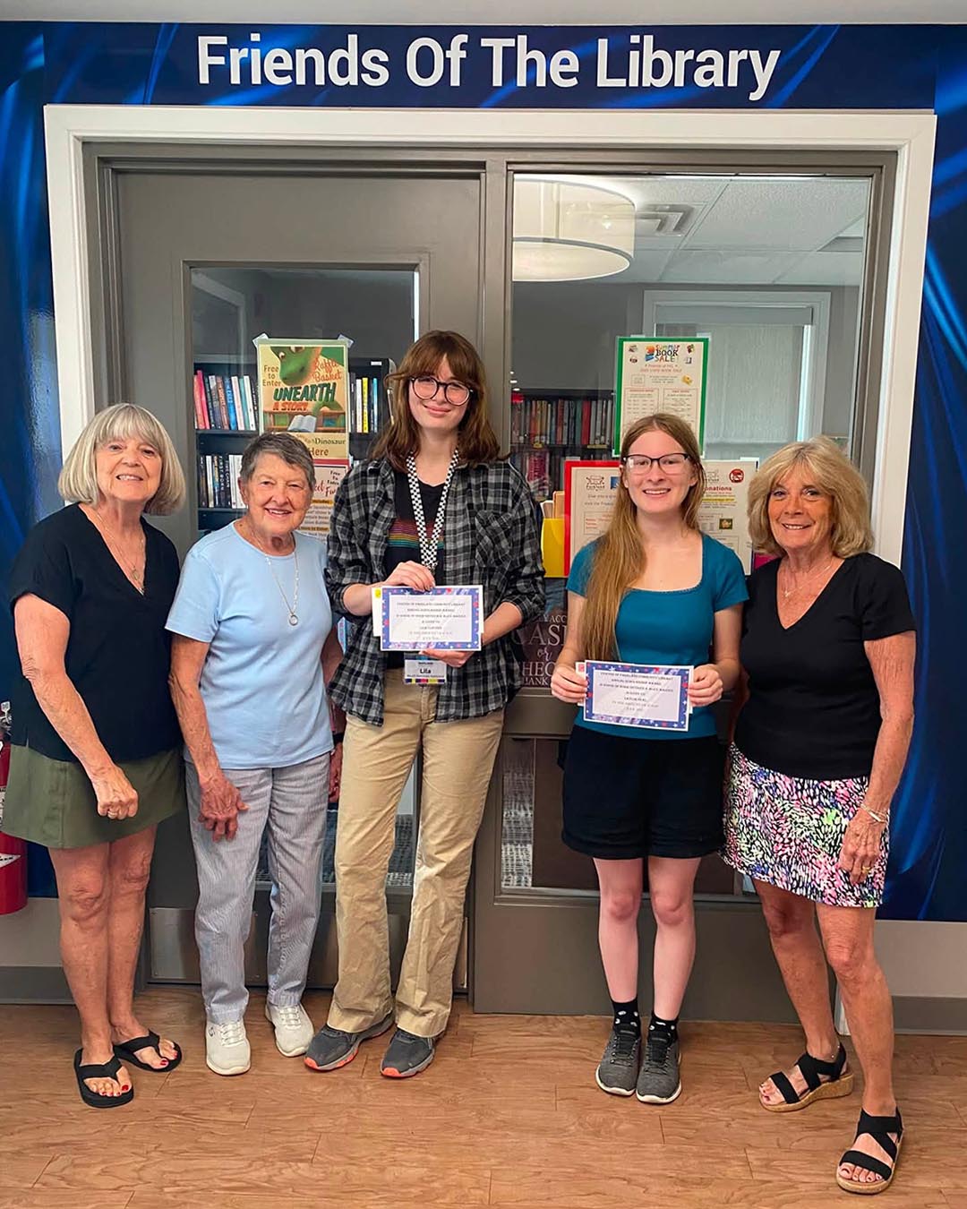 Friends of Parkland Community Library presented scholarships to Lila and Taylor.